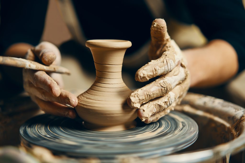 hands shaping pottery